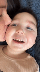 Woman kisses child in tender moment captured in Montenegro