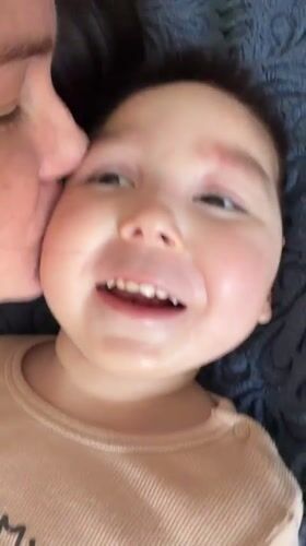Woman kisses child in tender moment captured in Montenegro