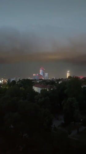 Storm clouds gather over Belgrade skyline at dusk