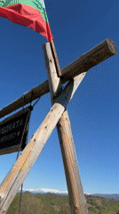Visitor documents scenic mountain viewpoint with swing set in Shipkovo