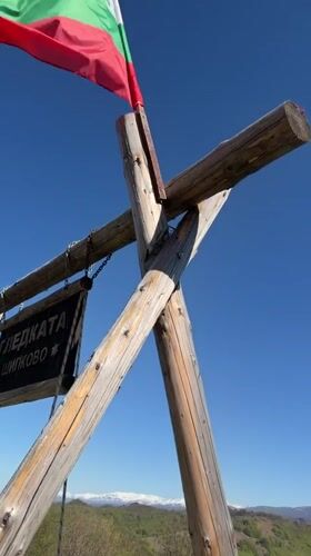 Visitor documents scenic mountain viewpoint with swing set in Shipkovo
