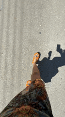 Person in colorful sandals walks paved street in Chania