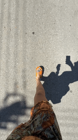 Person in colorful sandals walks paved street in Chania