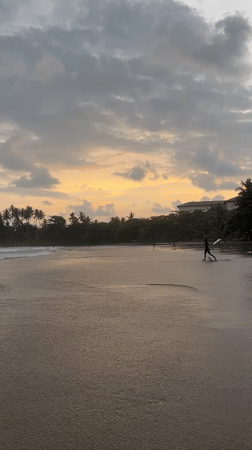 Surfers and sunset watchers enjoy cloudy afternoon at Galle beach