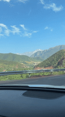 Driver records mountain scenery while traveling through Moroccan highlands