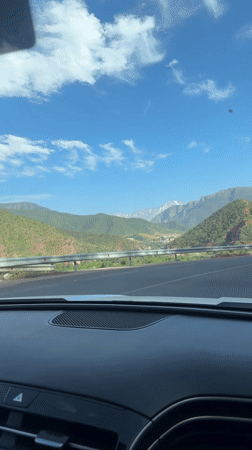 Driver records mountain scenery while traveling through Moroccan highlands