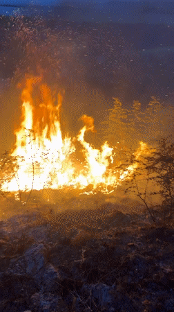 Wildfire spreads across hillside in Vranjina at dusk