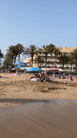 Crowded summer beach afternoon in Arona, Tenerife