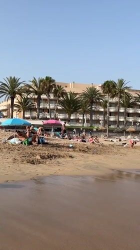 Crowded summer beach afternoon in Arona, Tenerife