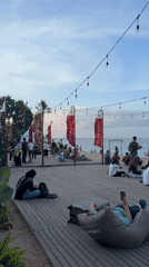 Morning beach activity captured across Denpasar boardwalk and restaurants