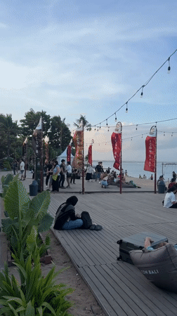 Morning beach activity captured across Denpasar boardwalk and restaurants