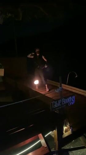 Fire dancers perform at nighttime beach party in Thailand