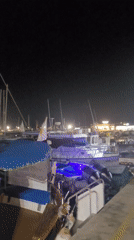 Limassol marina at night: boats, sculpture, and waterfront vibes
