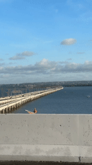 Bridge views and distant statue captured in Kuta