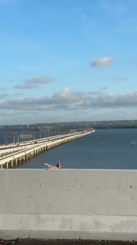 Bridge views and distant statue captured in Kuta