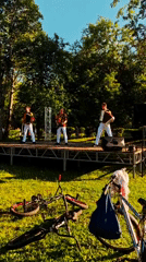 Musicians perform outdoor concert in Dubna park on sunny afternoon