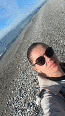 Woman takes selfie on sunny Batumi beach