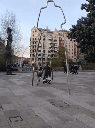Children play near sculpture in Burgos public square