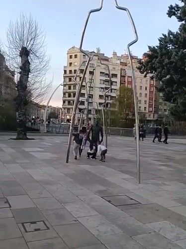 Children play near sculpture in Burgos public square