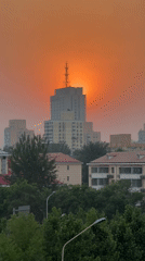 Orange sunset captured over Beijing's Chaoyang District skyline