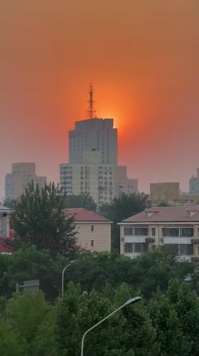 Orange sunset captured over Beijing's Chaoyang District skyline