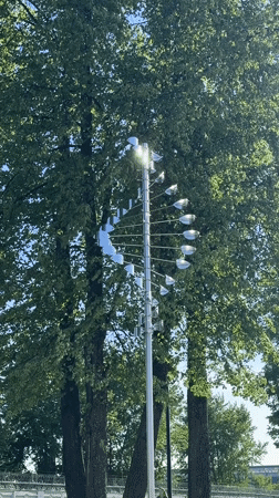 Person enjoys sunny day near kinetic sculpture in Votkinsk
