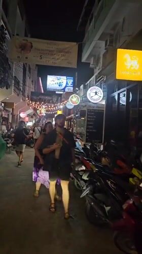 Busy nighttime street scene captured in Ko Tao, Thailand