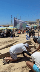 Three People Build Sand Fortification on Herzliya Beach