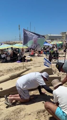 Three People Build Sand Fortification on Herzliya Beach