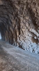 Camera captures journey through rock tunnel with natural exits
