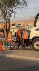 Utility workers perform sewer maintenance in Arica, Chile