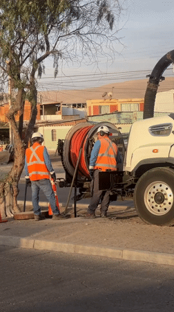 Utility workers perform sewer maintenance in Arica, Chile