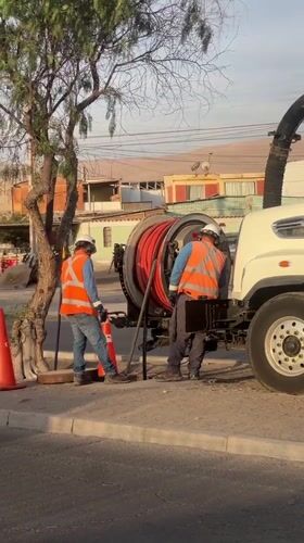 Utility workers perform sewer maintenance in Arica, Chile
