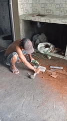 Construction worker cuts materials with grinder in Baron, Indonesia