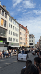 Street parade winds through Lübeck with bands, floats, and flags