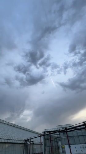 Storm clouds gather over greenhouse in Maidstone