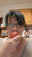 Woman enjoys fruit, poses playfully in Colorno evening