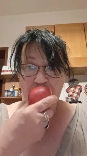 Woman enjoys fruit, poses playfully in Colorno evening