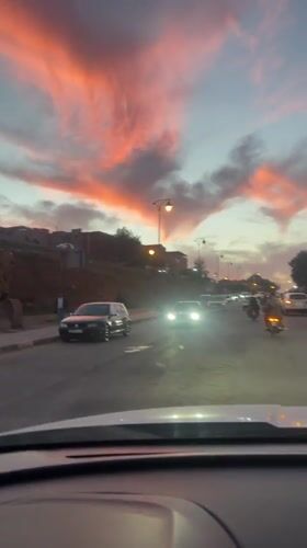 Evening traffic flows through Ourika streets at dusk
