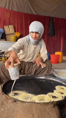 Street vendors prepare traditional jalebi sweets in Kandahar stalls