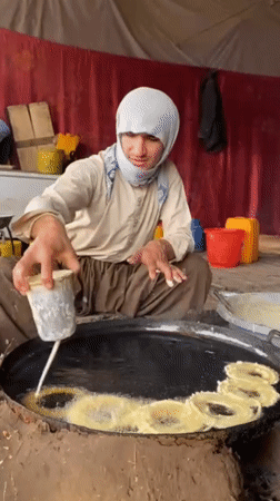 Street vendors prepare traditional jalebi sweets in Kandahar stalls