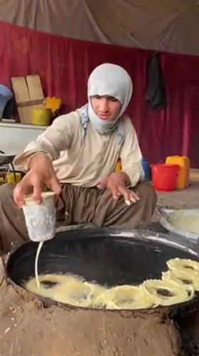 Street vendors prepare traditional jalebi sweets in Kandahar stalls