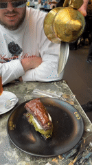 Person adds cream to baklava at Istanbul cafe