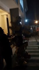 Robot costume and dancing captured at nighttime gathering