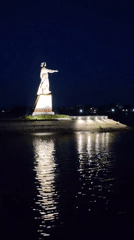 Dusk on the Volga: statue, ship, and still water in Rybinsk