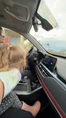 Woman drives with young passenger in Kamyshin, Russia