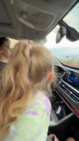 Woman drives with young passenger in Kamyshin, Russia