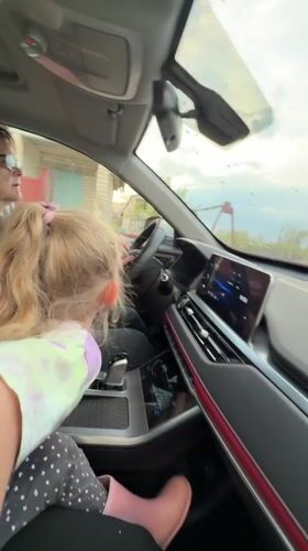 Woman drives with young passenger in Kamyshin, Russia