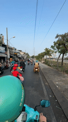 Motorcyclists navigate midnight traffic in Ho Chi Minh City