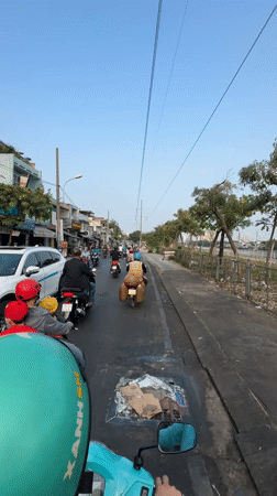 Motorcyclists navigate midnight traffic in Ho Chi Minh City